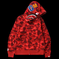 Red camouflage hoodie with a shark mouth graphic and colorful logo on the hood against a black background